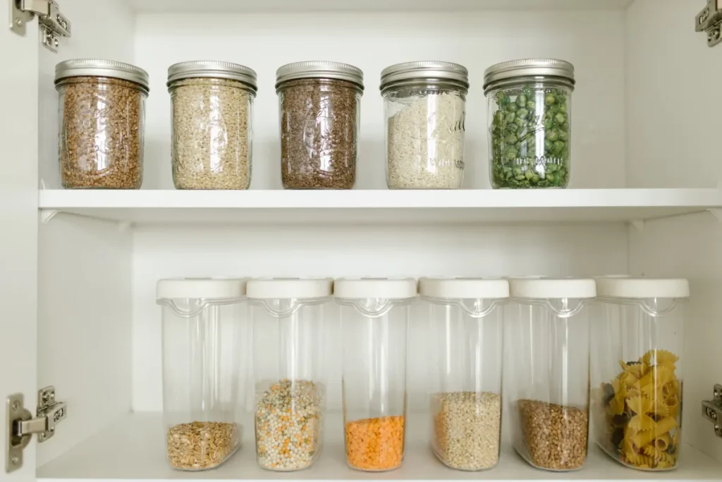 Dry food stored in sealed glass jars on a pantry shelf